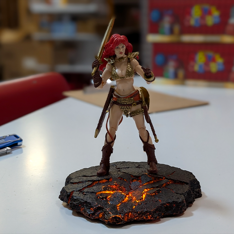 Red Sonja: Gold and Red Limited Edition Epic H.A.C.K.S. 1:12 Scale Action Figure - Boss Fight Studio on lava base