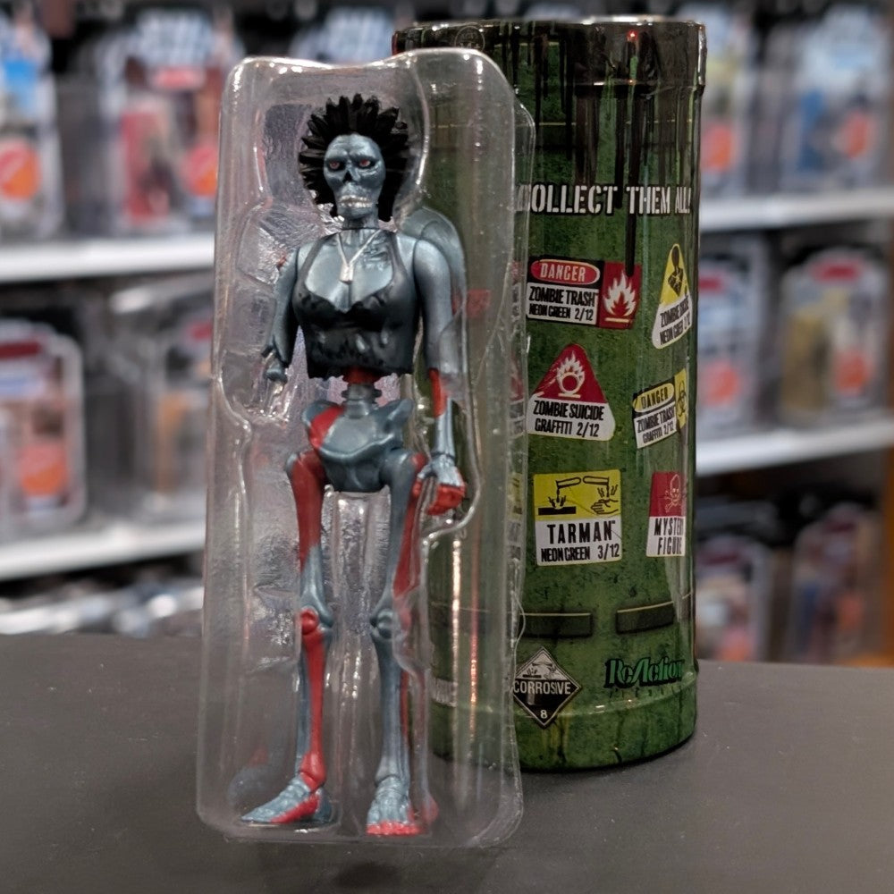 Super7 “Trash” metallic blue female zombie figure with spiked hair and torn red accents in clear blister packaging