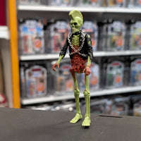 Super7 neon green male zombie figure with mohawk, exposed ribs, and red intestines wearing black jacket with chains on display