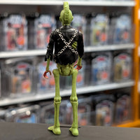 Super7 neon green male zombie figure with mohawk, black jacket with chains, and exposed skeletal details viewed from behind
