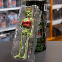 Super7 “Trash” neon green female zombie figure in torn red top displayed in clear blister packaging on store counter