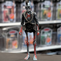 Super7 metallic blue graffiti male zombie figure with skeletal chest, red highlights, mohawk, and black jacket with chains standing upright