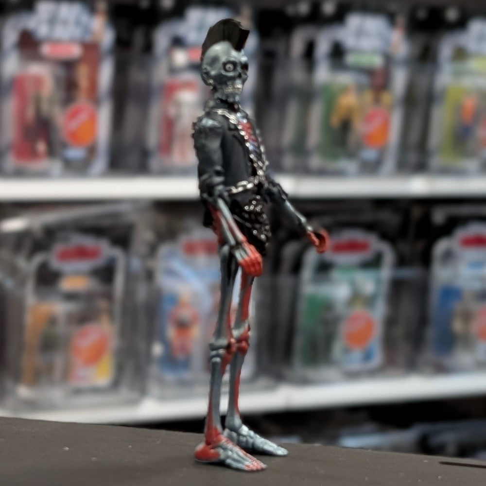 Super7 metallic blue graffiti styled male zombie figure with skeletal face, mohawk, black jacket, and chained accessories standing upright