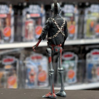 Super7 metallic blue graffiti male zombie figure with skeletal back, chains wrapped around black jacket standing on display