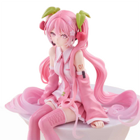 Hatsune Miku Noodle Stopper Figure Sakura Miku 2026 FuRyu Collectible seated with pink hair and cherry accessories