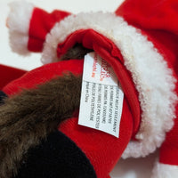 Close-up of Sekiguchi Monchhichi Boy Santa Claus plush tag showing fabric care details on red and white costume