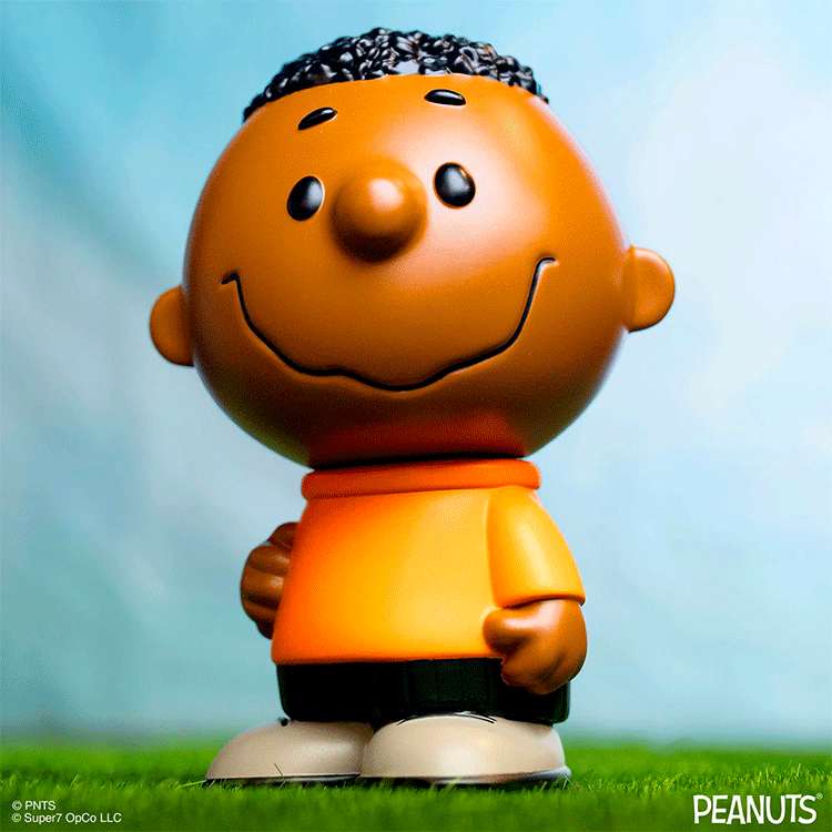 Funko Franklin Fun Fun Mascot vinyl figure from Peanuts wearing orange shirt standing on grass with blue background