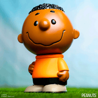 Funko Franklin Fun Fun Mascot vinyl figure from Peanuts wearing orange shirt standing on grass with blue background