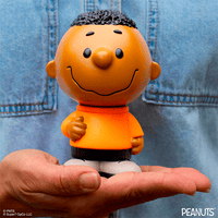 Funko Franklin Fun Fun Mascot vinyl figure from Peanuts held in hand wearing orange shirt and black shorts