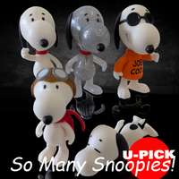 Super7 Peanuts ReAction 3.75-inch Snoopy figures including glitter, aviator, Joe Cool, and classic designs on black background