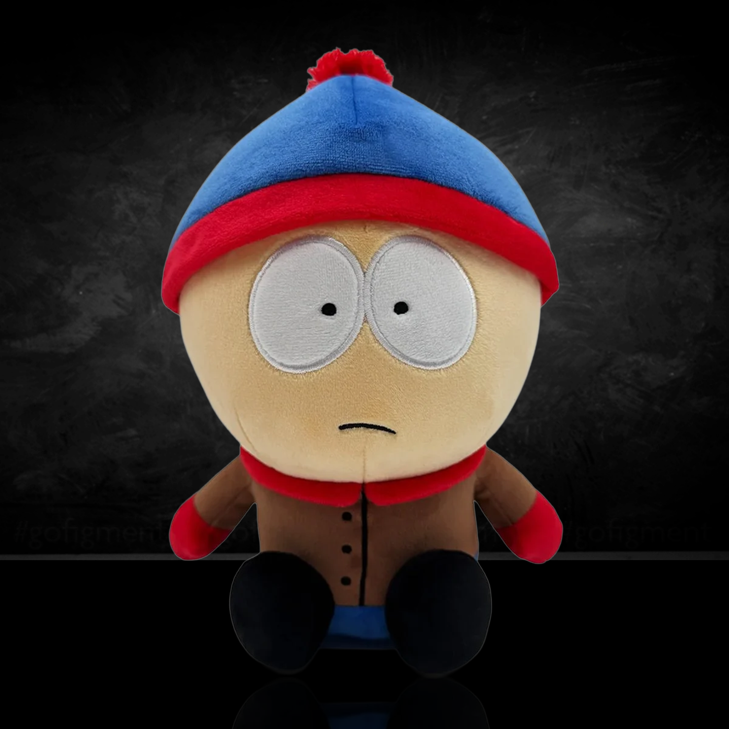 South Park Stan 9-Inch Plush by Youtooz dressed in blue hat and brown coat against dark background
