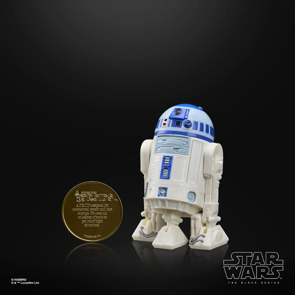 R2-D2 (Artoo-Detoo) Star Wars The Black Series Droids Action Figure by Hasbro displayed next to a collectible coin.
