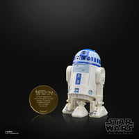 R2-D2 (Artoo-Detoo) Star Wars The Black Series Droids Action Figure by Hasbro displayed next to a collectible coin.