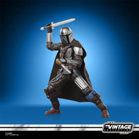 Star Wars The Vintage Collection The Mandalorian & Grogu Deluxe 3 3/4-Inch Action Figure by Kenner posed with sword on blue background