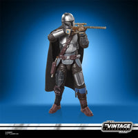 Star Wars The Vintage Collection The Mandalorian & Grogu Deluxe 3 3/4-Inch Action Figure by Kenner posed with rifle accessory