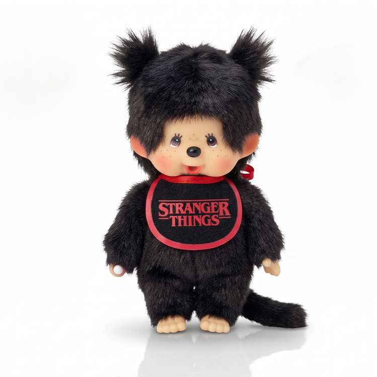 Black furry monkey doll with pigtails wearing a red Stranger Things bib on a white background