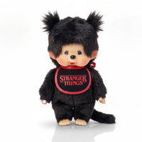 Black furry monkey doll with pigtails wearing a red Stranger Things bib on a white background
