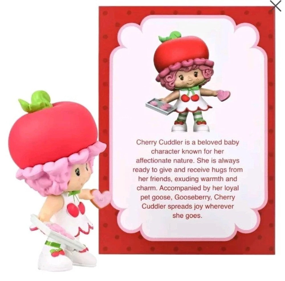 Cherry Cuddler 2.5" Strawberry Shortcake Cheebee Figure by Loyal Subjects with pink hair and red hat holding a heart-shaped object