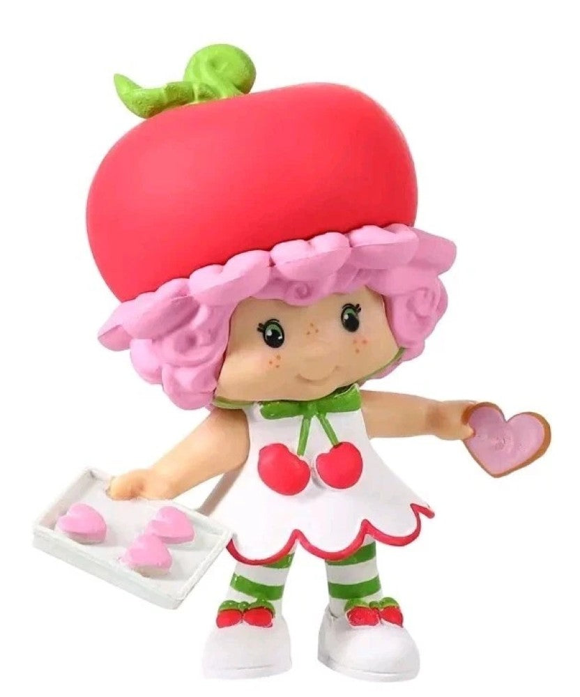 Cherry Cuddler 2.5" Strawberry Shortcake Cheebee Figure by Loyal Subjects holding pink heart cookies.