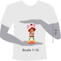 Boss Fight Studio Llc Strawberry Shortcake deluxe 1:12 scale figure with pink hat, striped tights, yellow shoes, and dessert accessory