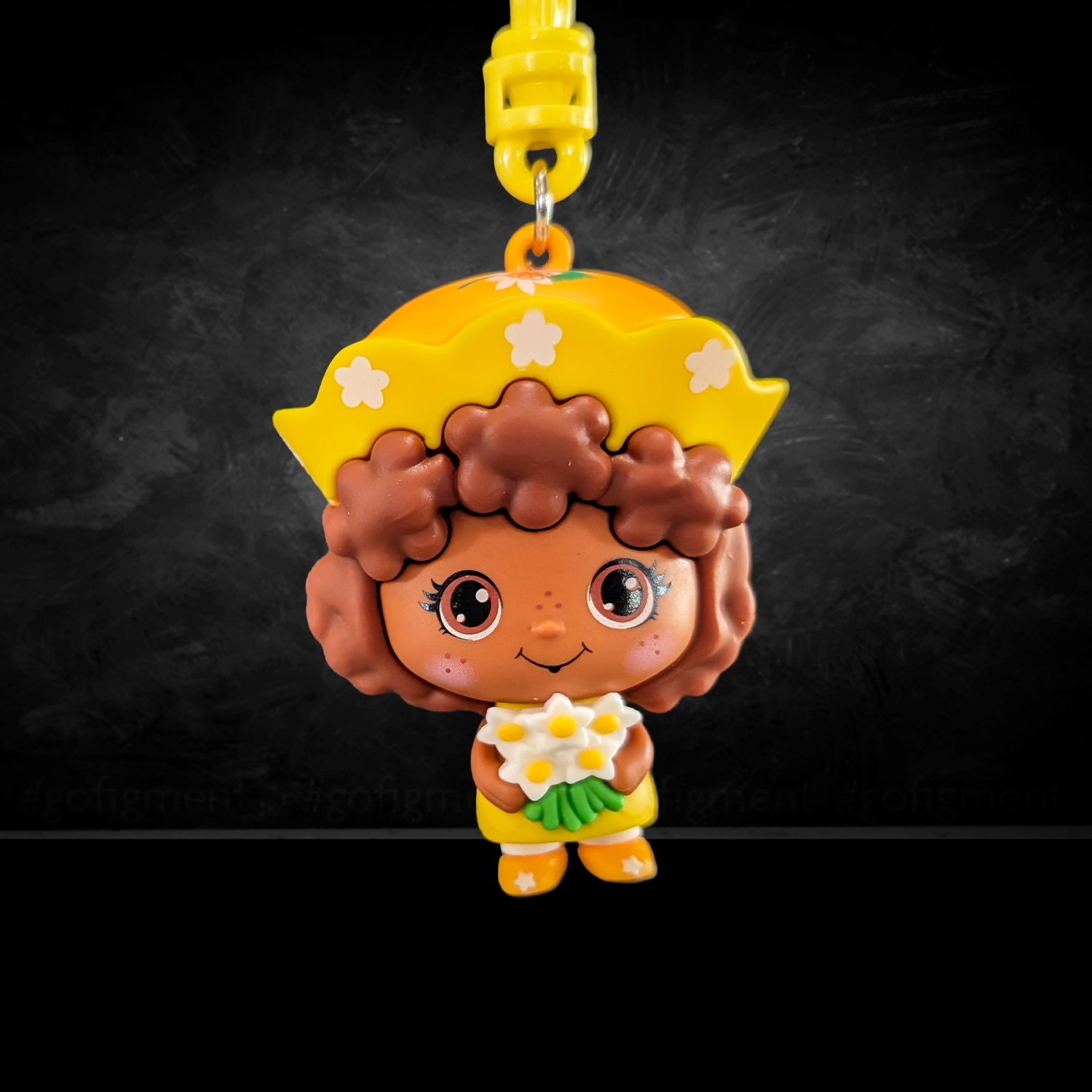 Strawberry Shortcake CheeBee U-PICK 2.5-Inch Keychain Blind Bag by Loungefly featuring a brown-haired character with yellow hat and flowers