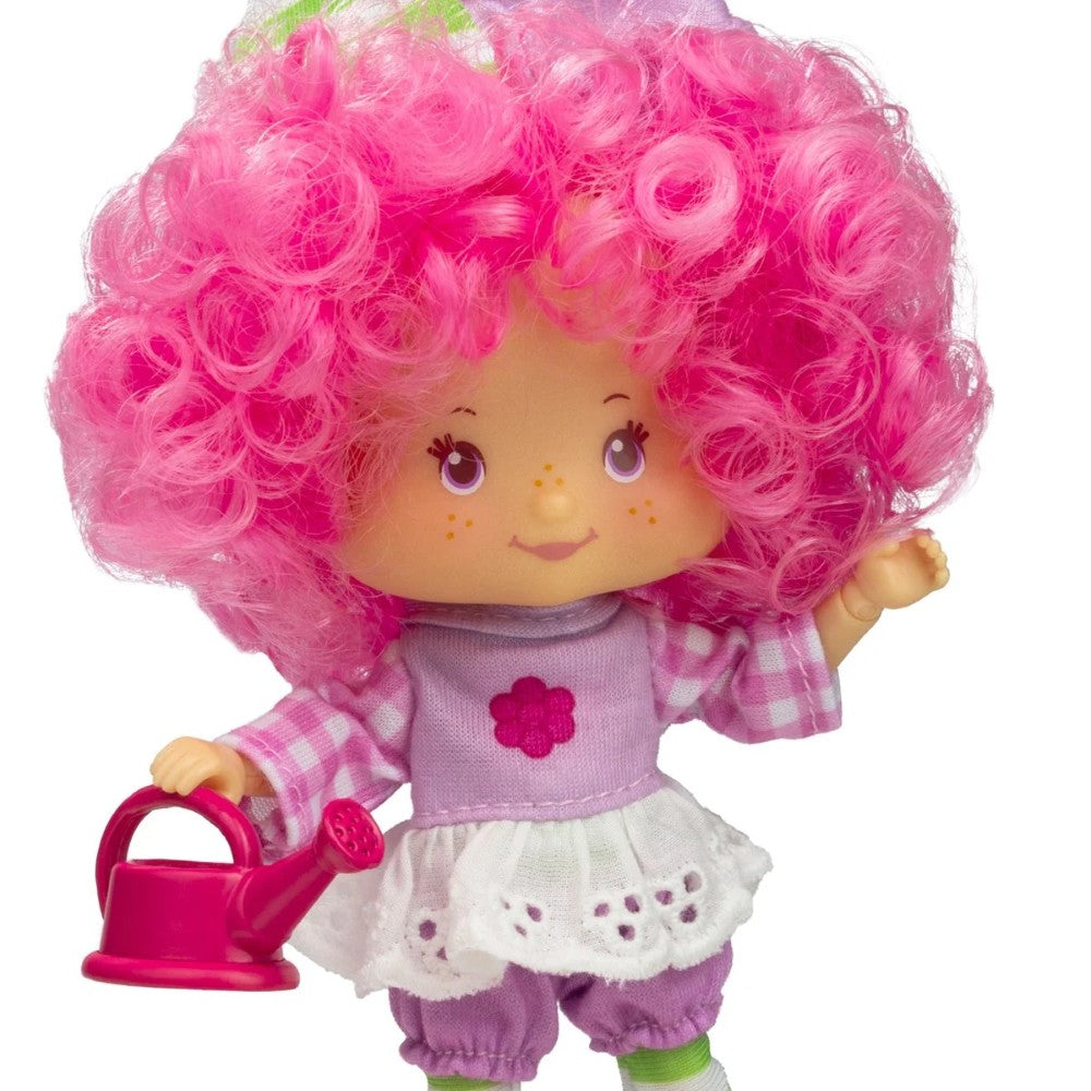 Loyal Subjects Strawberry Shortcake Raspberry Tart 5 1/2-inch fashion doll with pink curly hair holding pink watering can