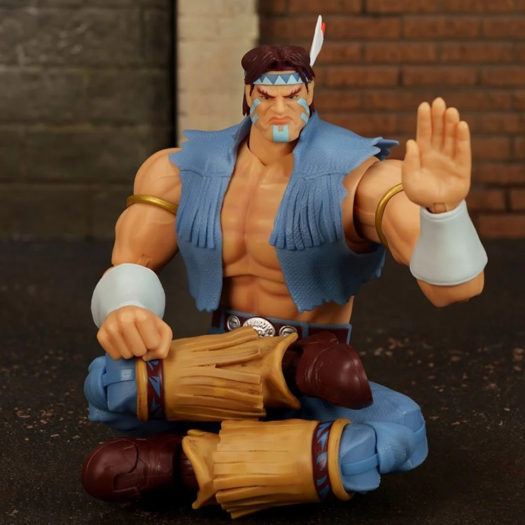 Ultra Street Fighter II T. Hawk 6-Inch Scale Deluxe Action Figure by Jada Toys seated with arm raised in martial pose