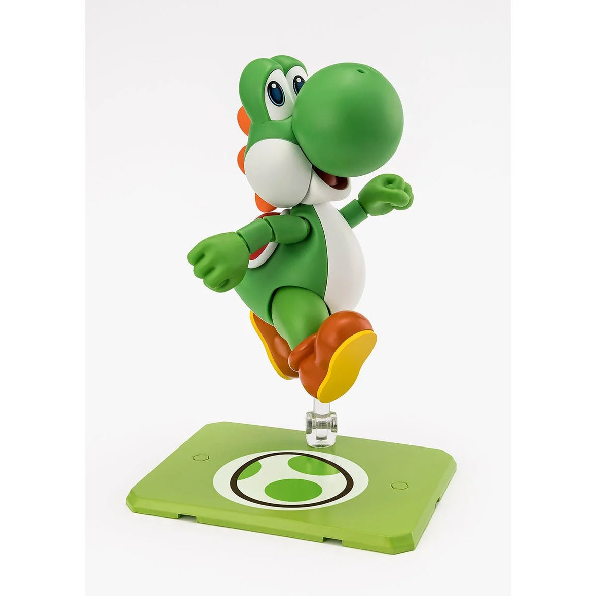 Articulated green Yoshi figure posed on a green display stand featuring a stylized egg symbol under a white background