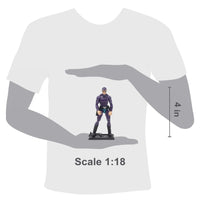 Small figurine held in a hand with a white t-shirt background, showing scale 1:18.
