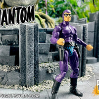Action figure in purple costume with mask standing on a stone surface with 'FIGHTSHOP.COM' branding.