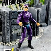 Superhero action figure in purple costume standing on a stone path with 'PHANTOM' text above.