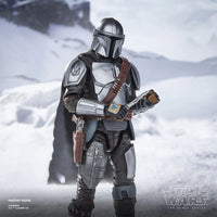 The Mandalorian & Grogu Deluxe Star Wars The Black Series 6-Inch Action Figure in armored suit holding a device in snowy scene new in box