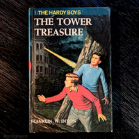 Vintage 1959 Hardy Boys book The Tower Treasure with blue bar and red number one on cover by Grosset & Dunlap