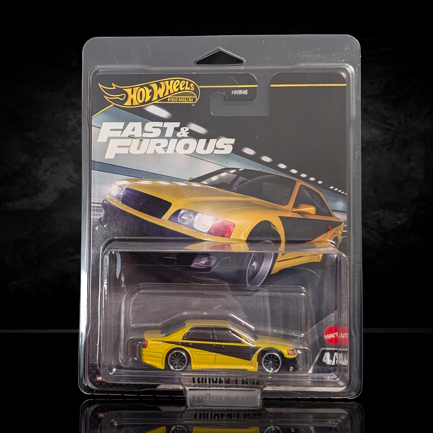 Hot Wheels Fast & Furious die-cast yellow sports car with black stripe in premium blister packaging