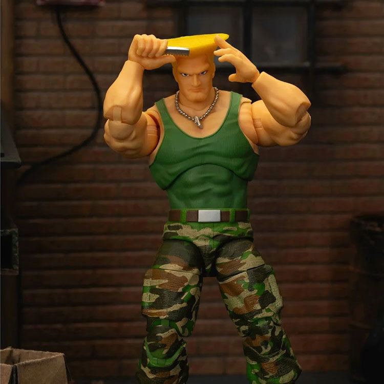 Jada Toys Ultra Street Fighter II Colonel Guile 6-inch action figure in green tank top and camo pants holding comb