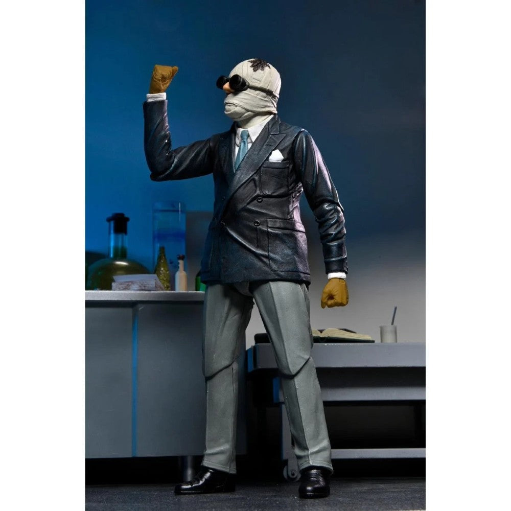 The Invisible Man Universal Monsters Ultimate Action Figure NECA 7” posed wearing suit, goggles, and mustard gloves collectible toy by Neca