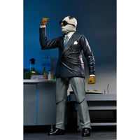 The Invisible Man Universal Monsters Ultimate Action Figure NECA 7” posed wearing suit, goggles, and mustard gloves collectible toy by Neca