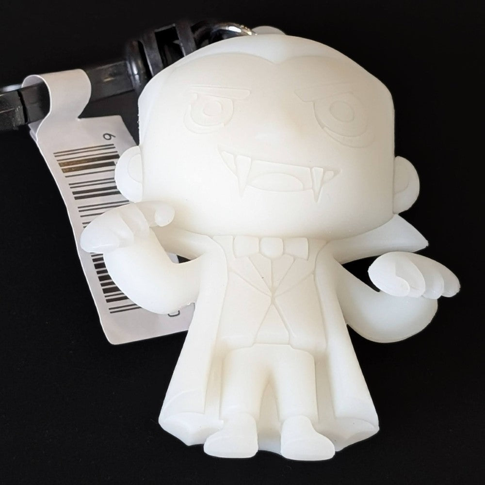Go Figment Universal Monsters Series 4 white Dracula figural bag clip with attached keyring and barcode tag on black background