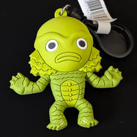 Go Figment Universal Monsters Series 4 green creature 3D foam bag clip with attached keyring and barcode tag on black background