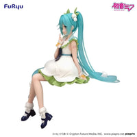 Hatsune Miku Flower Fairy Lily of the Valley Noodle Stopper Figure FuRyu by Banpresto with blue hair and white green dress sitting pose