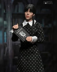 Wednesday Addams Classic Dress 8-Inch Clothed Action Figure NECA holding Frankenstein book with braided hair in black patterned dress new in box collectible