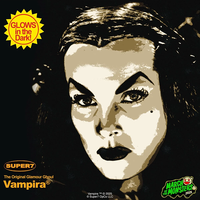 Stylized close-up of Vampira's face with dramatic makeup and a glow-in-the-dark promotional badge.