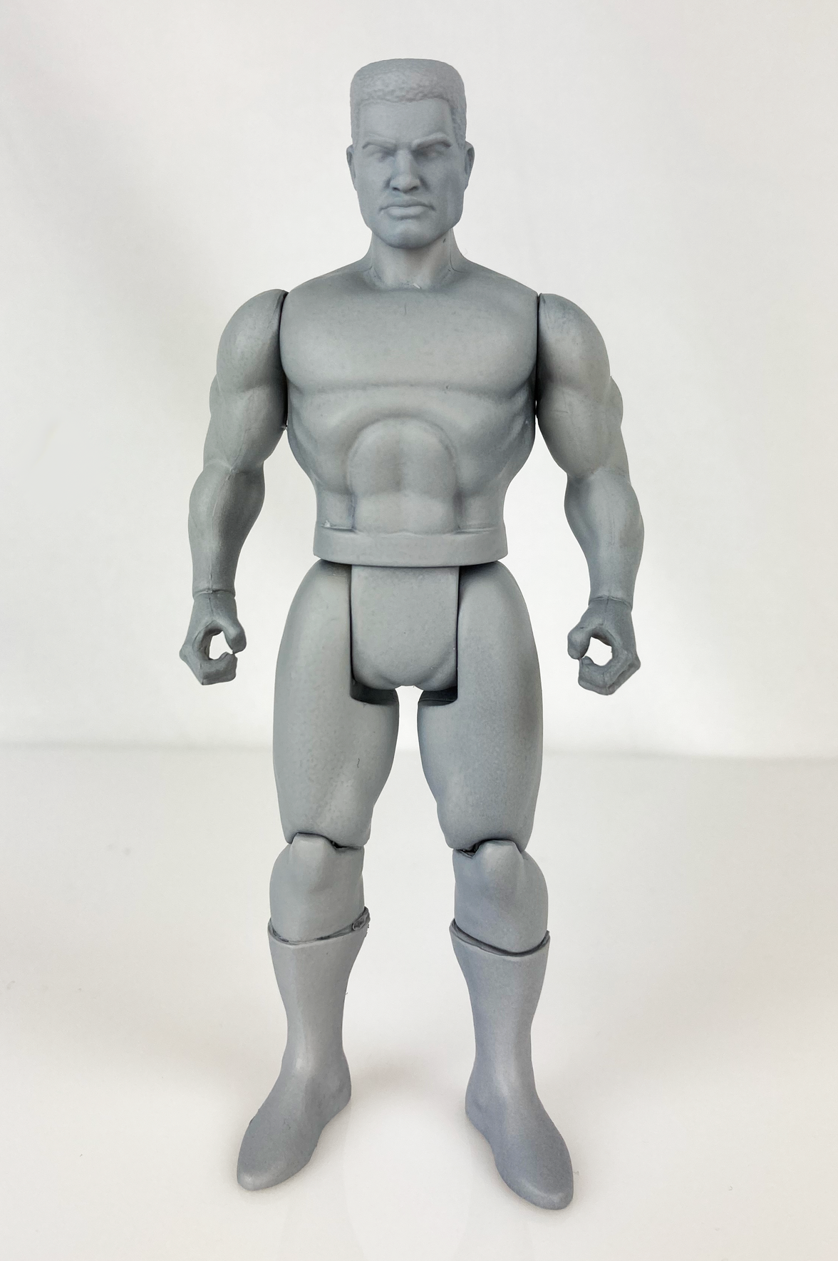 Boss Fight Studio Llc 5-inch gray blank muscular action figure with articulated joints on white background