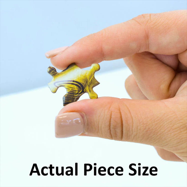 Close-up of hand holding one puzzle piece showing actual size from Master Pieces Big Foot 300 piece jigsaw puzzle