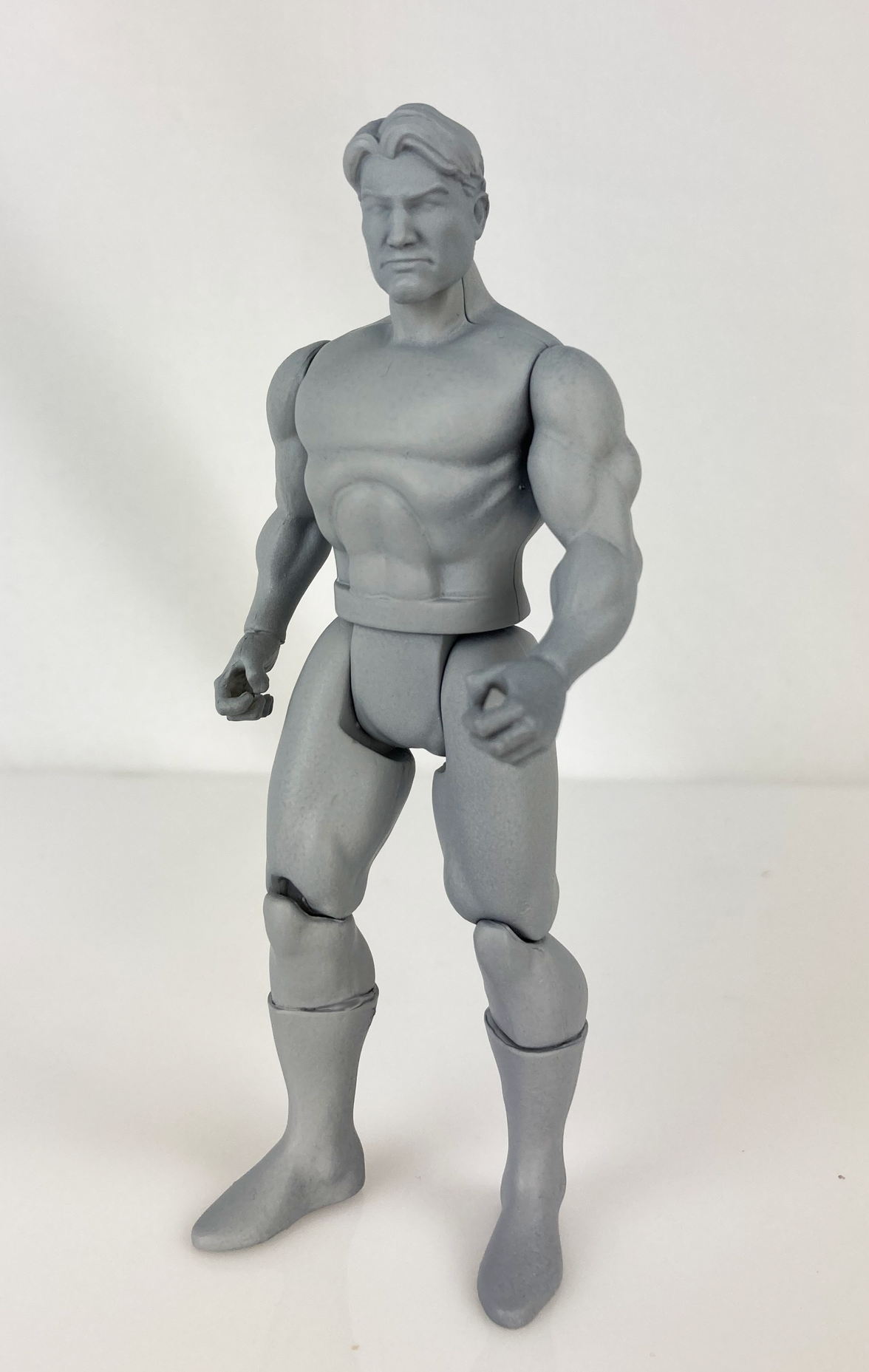 Boss Fight Studio Llc 5-inch gray blank retro-style action figure with muscular build and articulated joints on white background