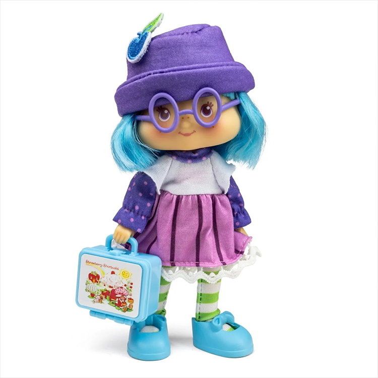Loyal Subjects Strawberry Shortcake Plum Pudding doll with blue hair, purple outfit, glasses, and carrying a lunchbox on white background