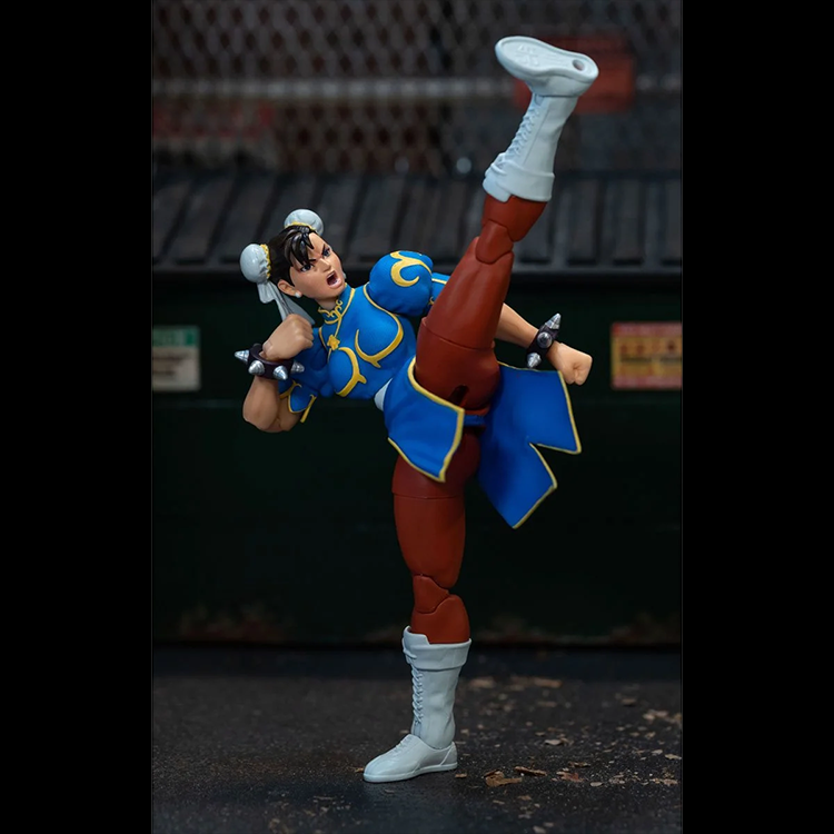 Jada Toys Ultra Street Fighter II Chun-Li action figure performing high kick pose on urban background