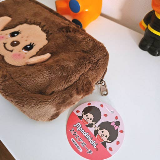 Official Sekiguchi Monchhichi Square Plush Pouch by K-Wonderland featuring a soft spacious character design, often searched as a Monchichi organizer.