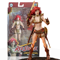 Red Sonja: Gold and Red Limited Edition Epic H.A.C.K.S. 1:12 Scale Action Figure - Boss Fight Studio posed with packaging visible behind