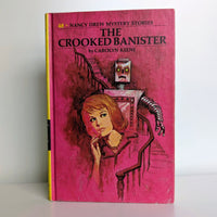 Vintage Grosset & Dunlap Nancy Drew Mystery Stories The Crooked Banister hardcover book with pink cover artwork